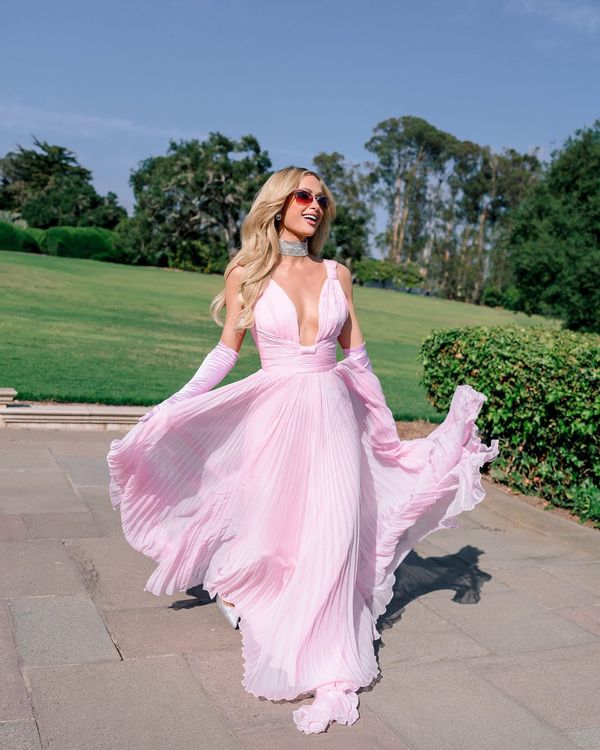 Paris Hilton wearing a pink celebrity wedding guest for Demi Lovato's wedding