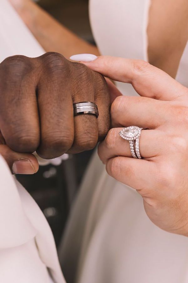 Bride and groom showing off new wedding bands with lab grown diamond engagement ring for bride