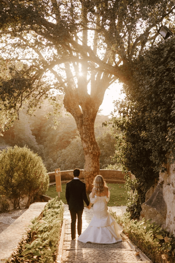 Bride and groom walking through the gardens of Valverde Sintra Palácio de Seteais in Portugal at sunset - best wedding venues in Portugal