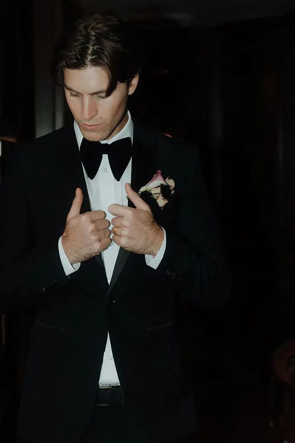 Groom wearing a black wedding suit and bowtie
