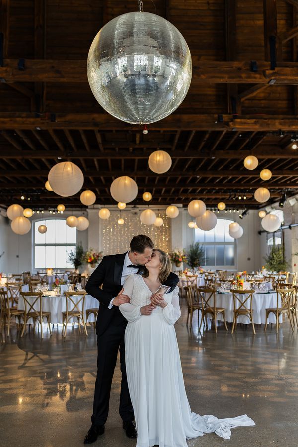 Bride and groom under disco ball at Trinity Buoy Wharf Sofia yang martinez Photography 