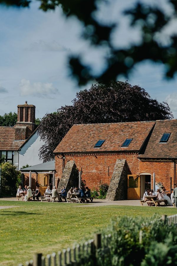 Photograph credit: James Merrick Photography. Photograph of The Paddock and Top Barn with a view of Moat Hall in the background.
