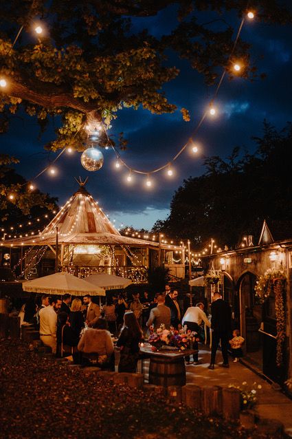 As the sun sets and your evening guests arrive, enjoy cocktails on the patio adorned with festoon lights and disco balls. Photo credit: Kit Myers