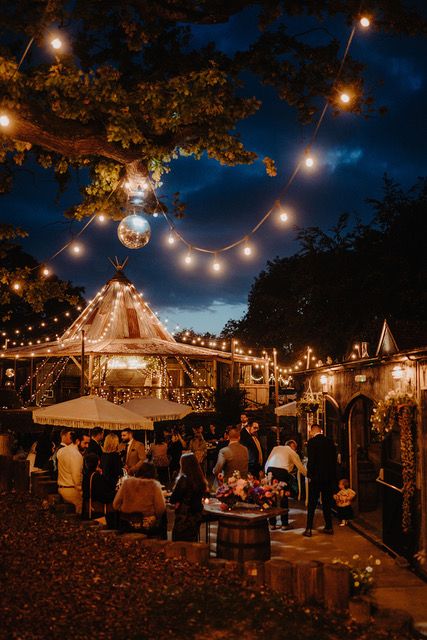 As the sun sets and your evening guests arrive, enjoy cocktails on the patio adorned with festoon lights and disco balls. Photo credit: Kit Myers