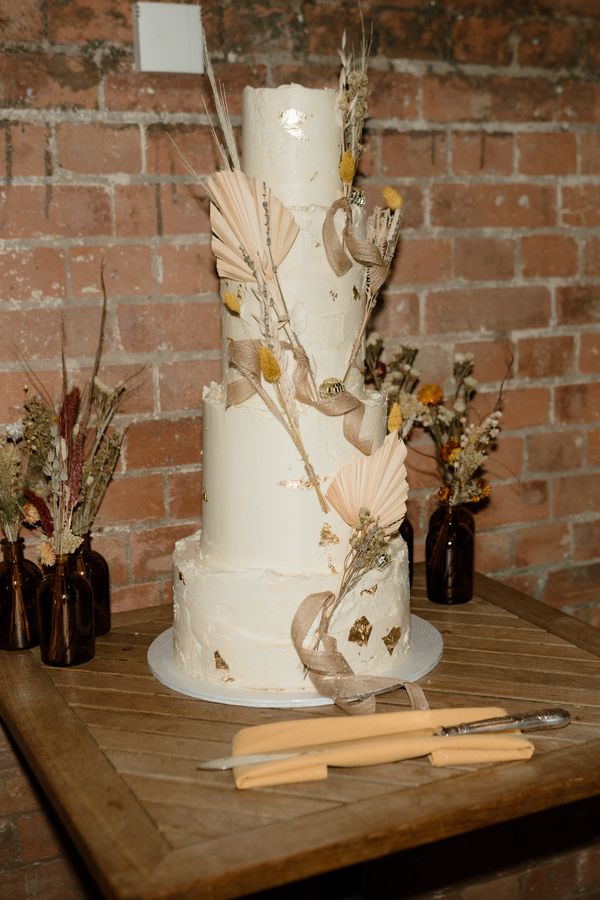 Boho classic cake with gold highlights over four tiers, photo by Bates & Bates