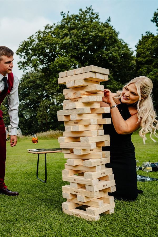 Wedding guests enjoying an intense game of giant Jenga during the drinks reception, bringing laughter, competition and plenty of unforgettable moments to the day. 