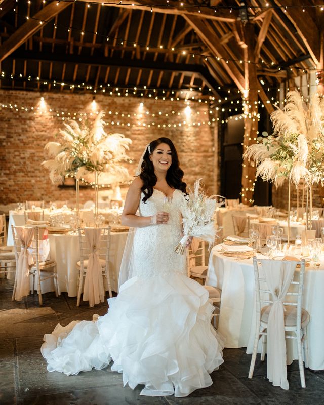 Intimate Cooling Castle Barn wedding with neutral colour scheme, dried flowers and fishtail wedding dress.