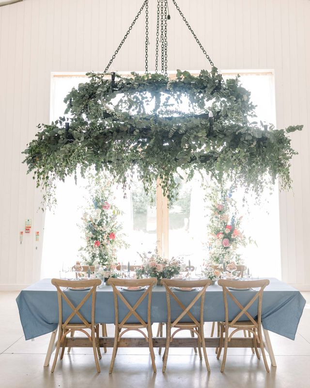 Pastel wedding inspiration at The White Barn in Somerset with vertical floral arrangements