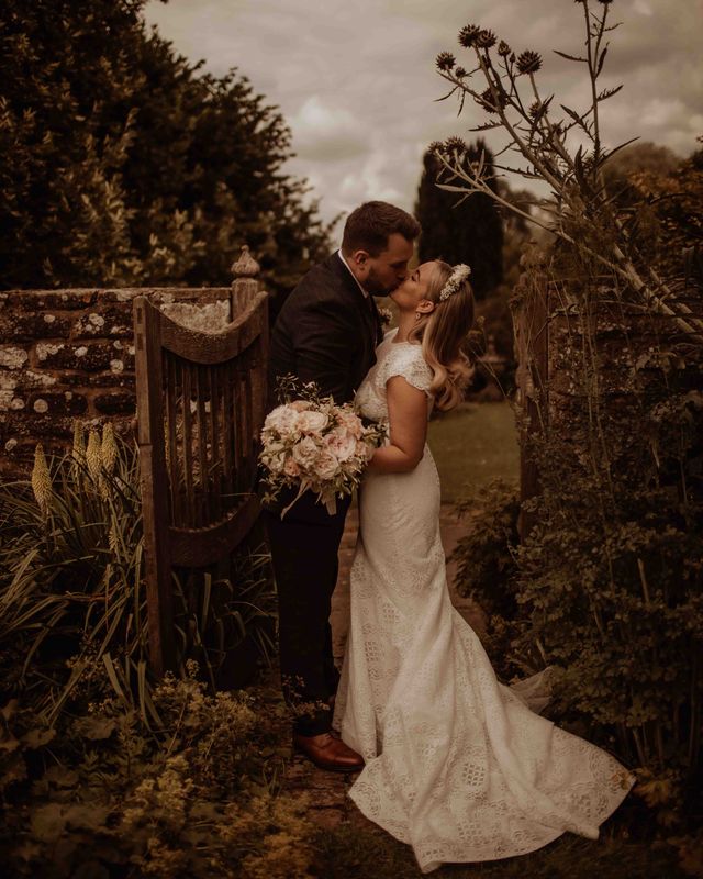 outdoor wedding at Dewsall court with bride in a lace cap sleeve wedding dress