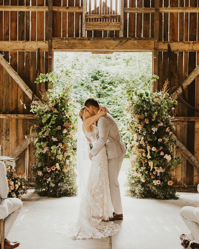 Bride and groom share their first kiss as a married couple at Nancarrow Farm.