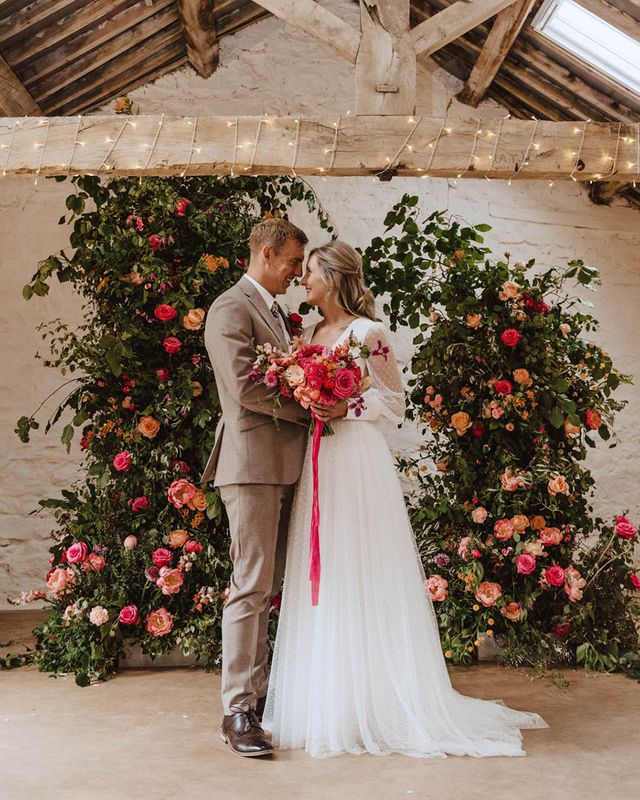Bride in Sassi Holford wedding dress with the groom for rustic wedding.