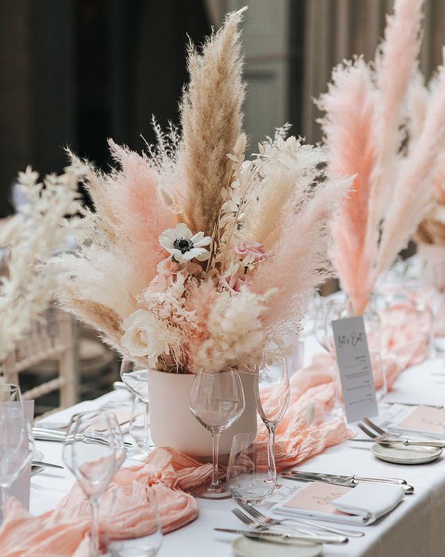 Pink and white pampas grass centrepiece decor for boho wedding.