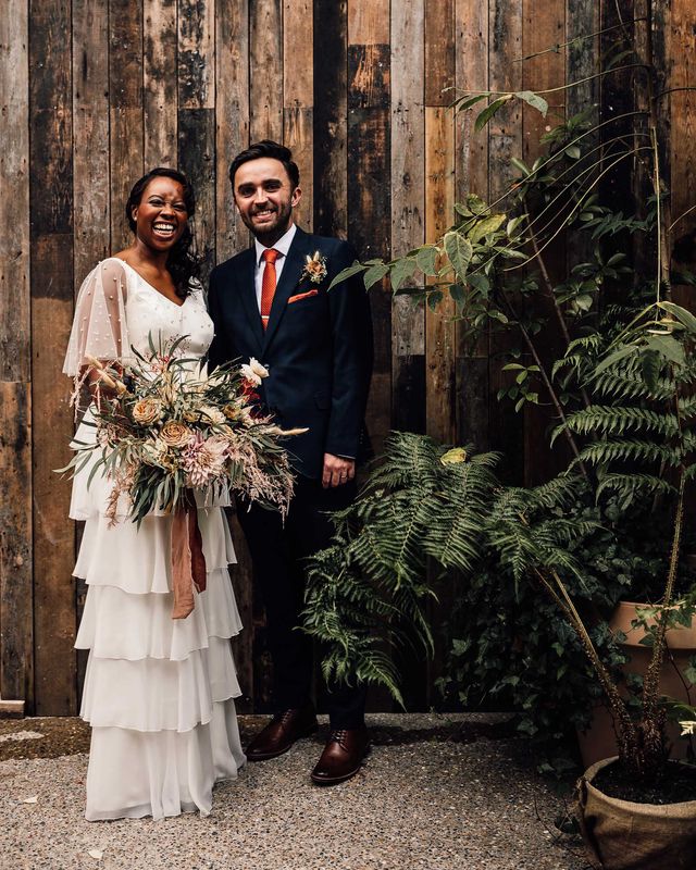 Black bride in a bespoke wedding dress at 100 Barrington wedding venue with pampas grass decor