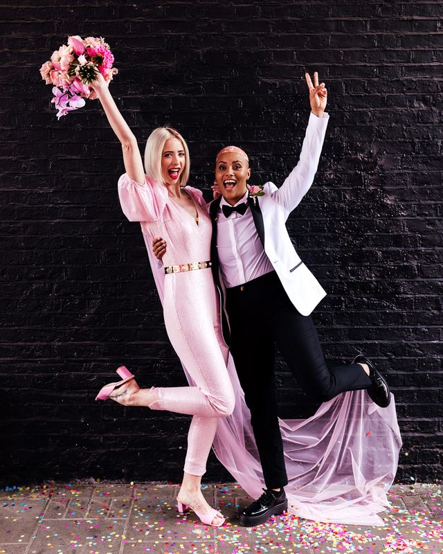 Alternative wedding inspiration with two brides in a pink jumpsuit and white tuxedo jacket