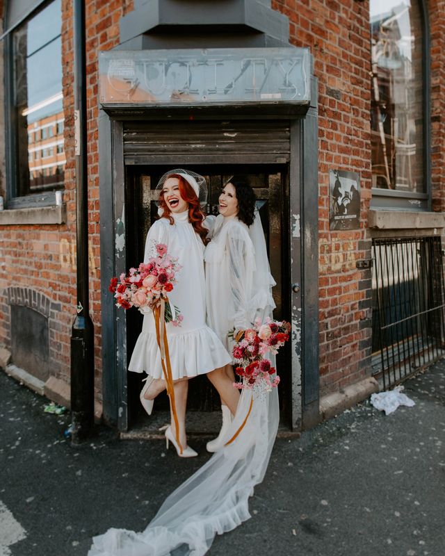 short wedding dress long veil bridal inspiration with red wedding flowers, winged eyeliner and bold lipstick