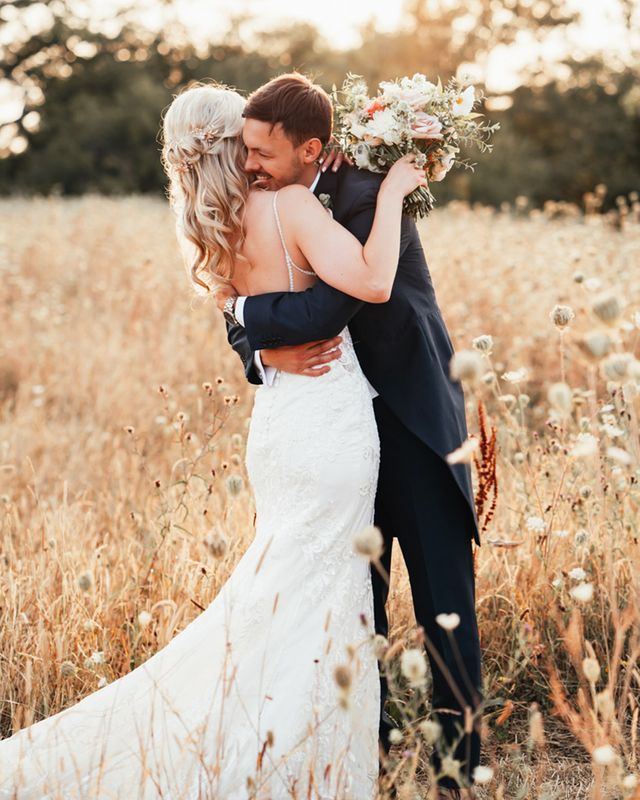 Bride and groom posing together at Rackleys Chiltern Hills barn wedding venue in Buckinghamshire.