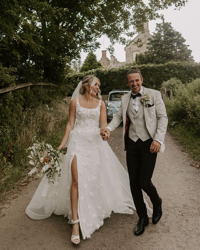 Bride in Eleganza Sposa Iconic wedding dress with groom. 