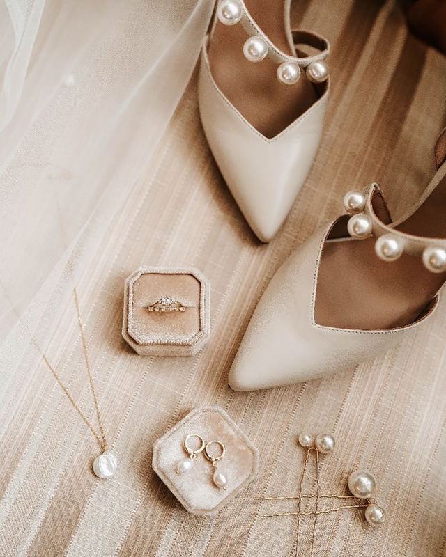 Luxe pearl and gold wedding necklace, earrings and hair pins with a diamond engagement ring and white pearl wedding shoes