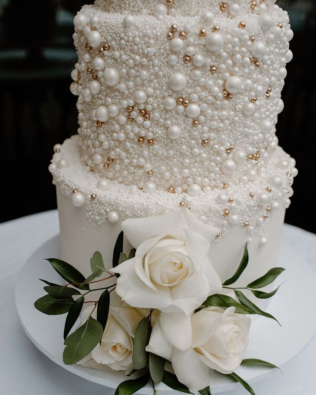 White iced four tier wedding cake with pearl design