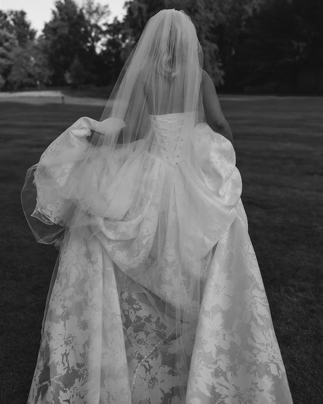 Bride wearing floral corset wedding dress with long train
