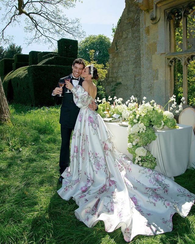 White spring wedding dress with train and pink floral pattern