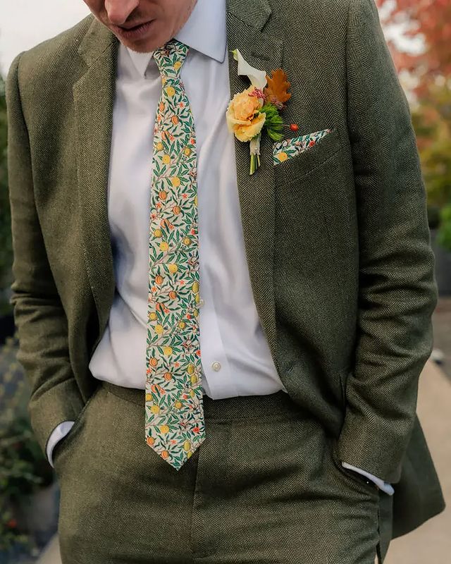 Groom wearing green floral patterned wedding tie 