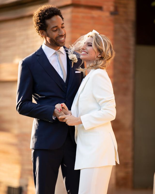 Couple wearing Hockerty and Sumissura custom bride and groom wedding suits