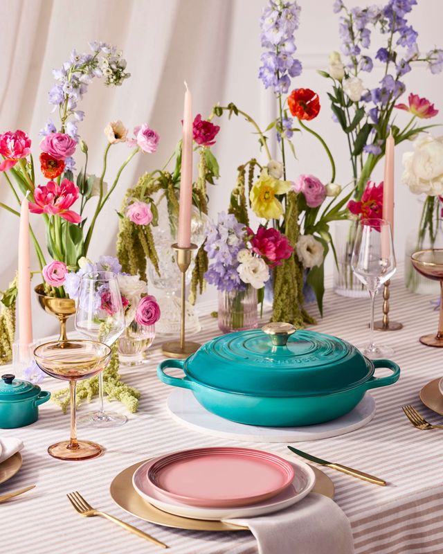 Le Creuset Bleu Riviera new cast iron casserole dish styled on a colourful wedding tablescape with pastel florals, glassware and modern table decor