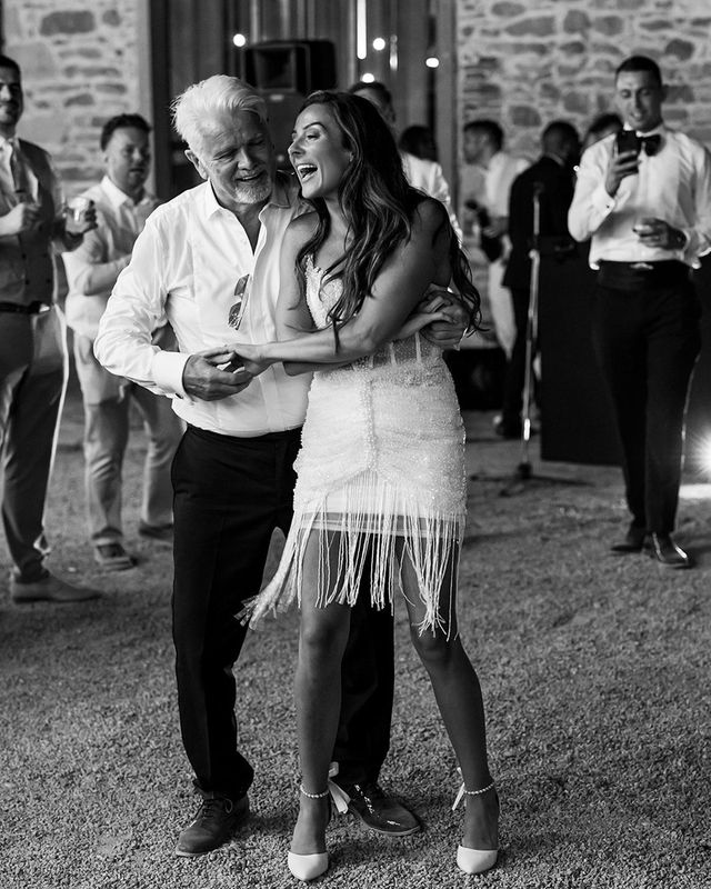 Bride dancing with the father of the bride in a white shirt