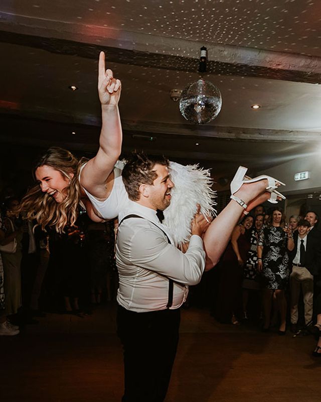 bride and groom having fun during their first dance for best oasis wedding songs