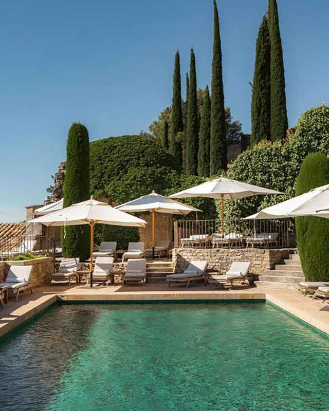 Pool area of luxury hotel in restored village in Provence for minimoon