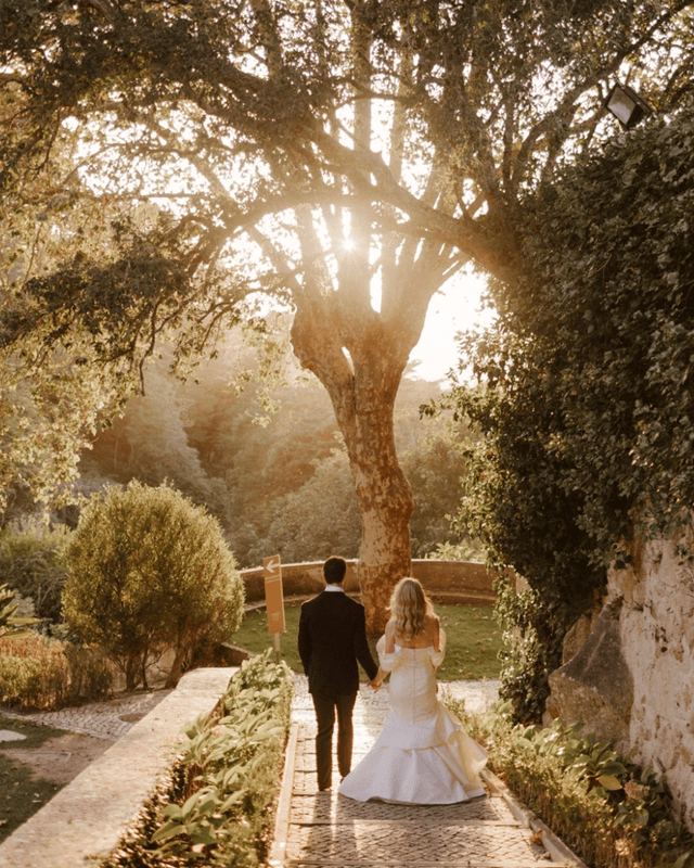Bride and groom walking through the gardens of Valverde Sintra Palácio de Seteais in Portugal at sunset - best wedding venues in Portugal
