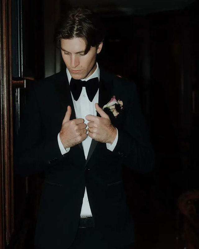 Groom wearing a black wedding suit and bowtie