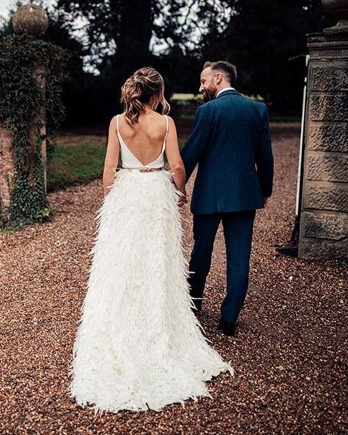 Charlie Brear Payton Bridal Gown & Piora Feather Skirt with Deep Red, Grasses & Pheasant Feather Floral Installation at Iscoyd Park, shot by Harry Michael