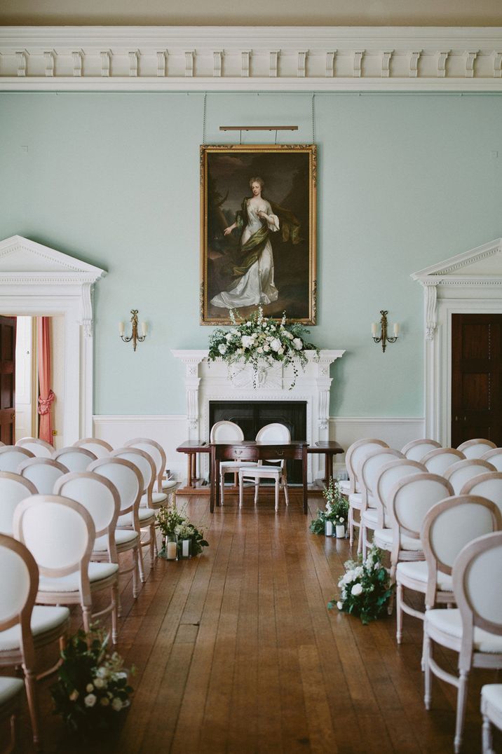 Classic Kirtlington Park wedding with Louis chairs and green and white ceremony flowers 