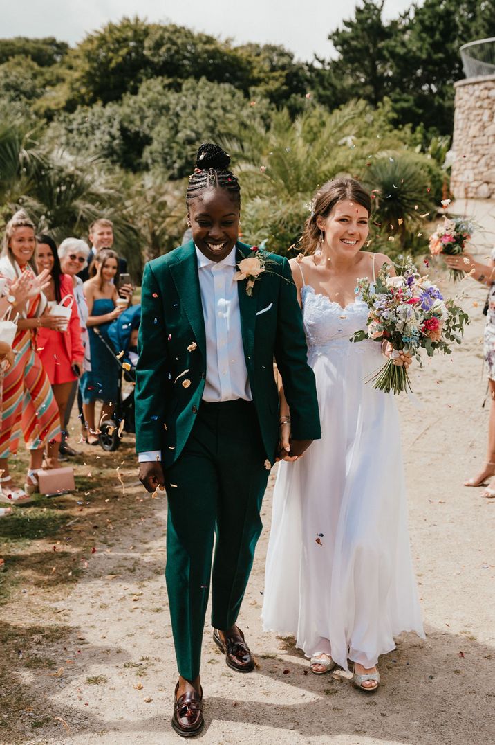 Confetti moment at Lesbian wedding with two brides in a green wedding suit and Grace Loves Lace wedding dress