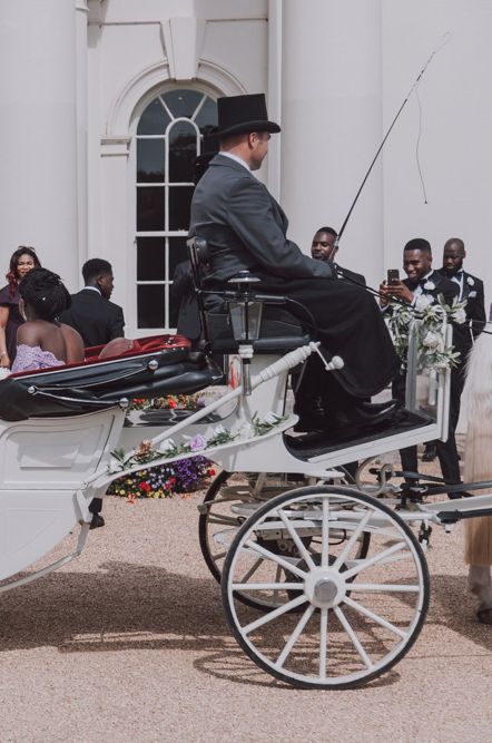 Bride in princess wedding dress in classic white horse drawn carriage