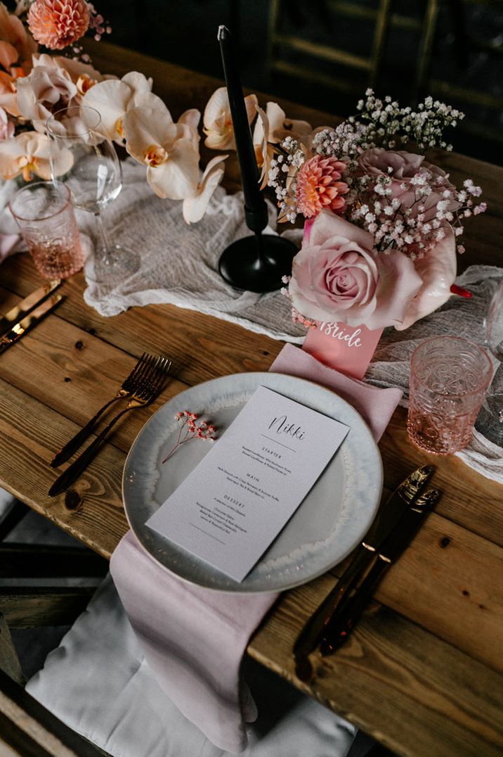 wedding place setting with menu card and centrepiece flowers