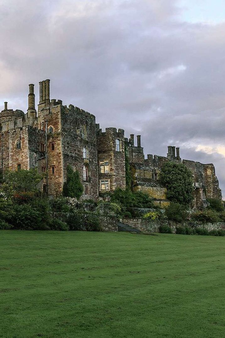 Exterior of Berkeley Castle wedding venues with manicured lawns and dramatic skies 