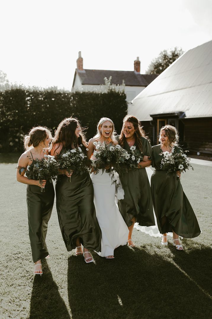 Bridesmaids in matching green satin bridesmaid dresses by Rewritten Bridesmaids Dresses 