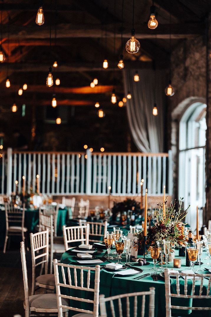 Green theme wedding and tablescape at wedding breakfast with festoon lighting 