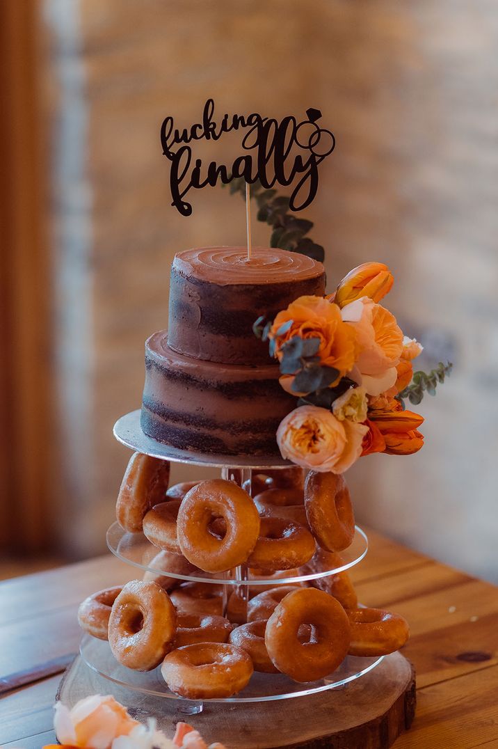 Doughnut tower with personalised black wedding cake topper 