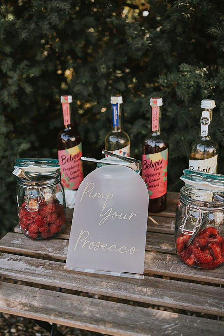 Pimp your own prosecco station at wedding featuring raspberries and strawberries Poppy Carter Portraits