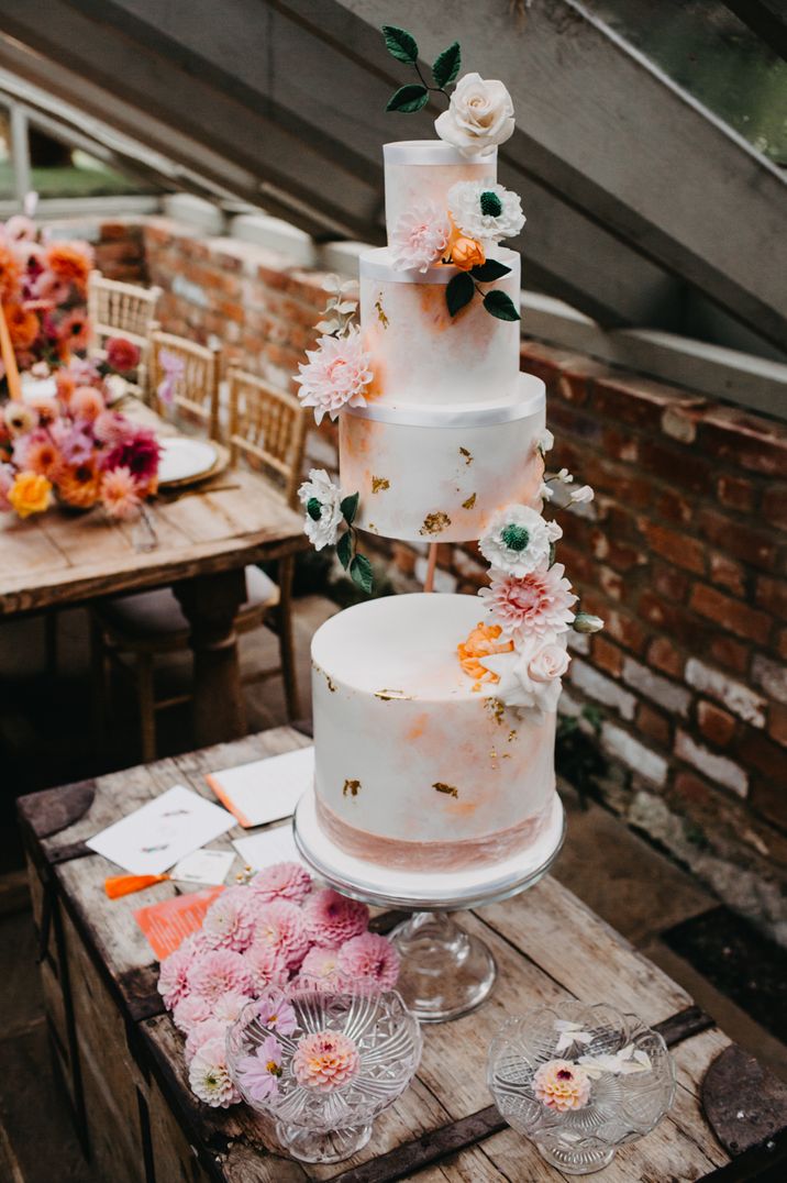 Three tier wedding cake with peach and gold contemporary design