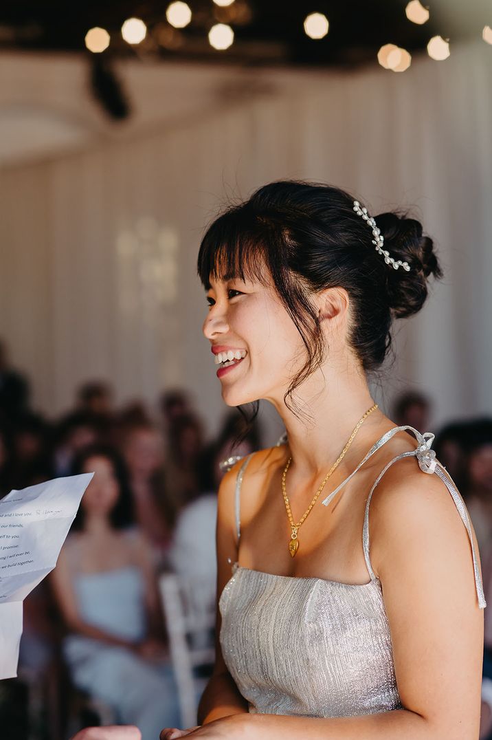 Bride wears gold heart shaped necklace and sparkly wedding dress