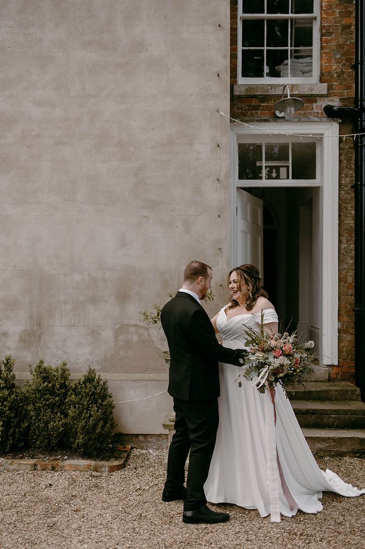 Bride and groom embrace as they see each other for the first time on the morning of the wedding before the ceremony 