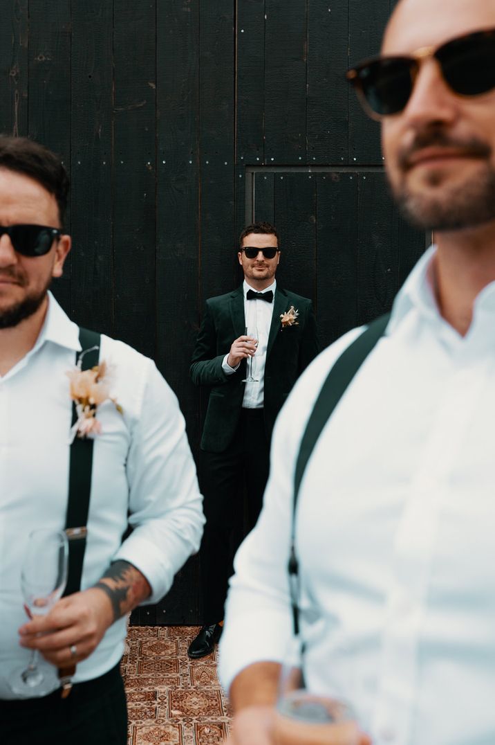 Groom and groomsmen in sunglasses and suits