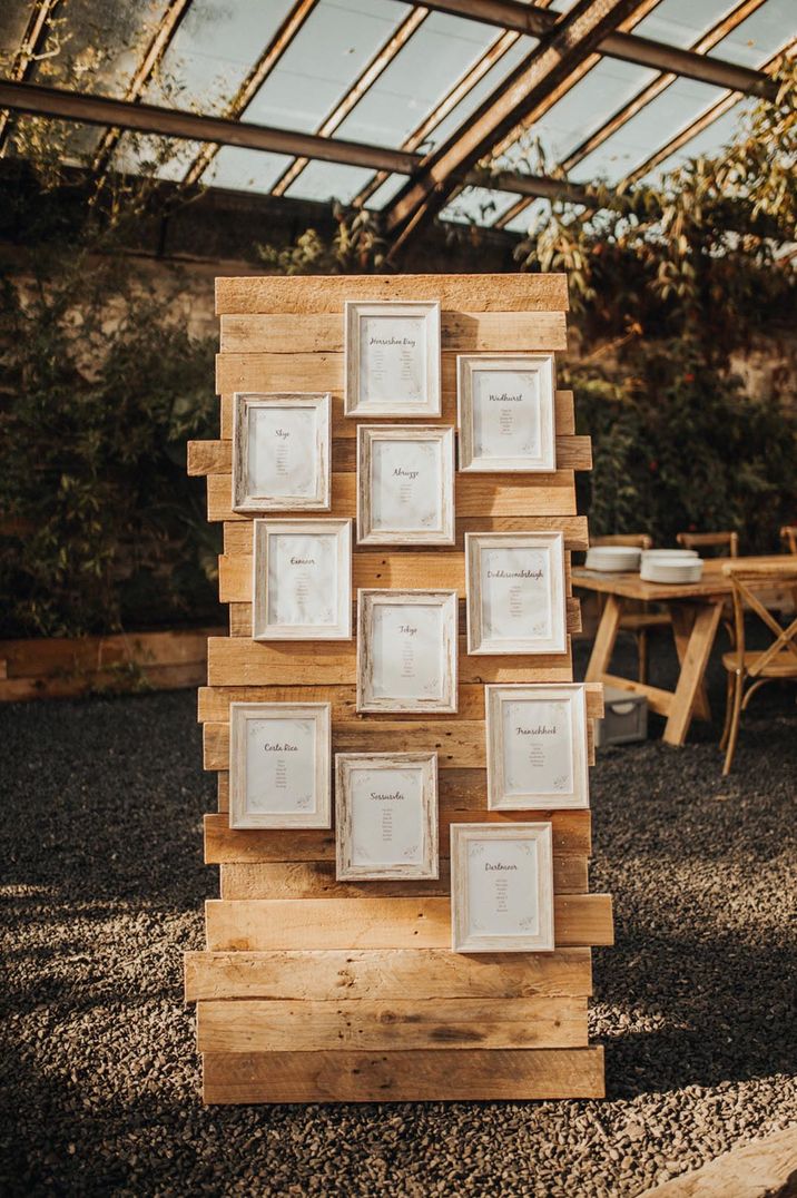 Light wooden rustic seating chart with photo frames 