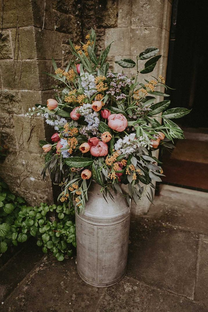 colourful milk churn wedding flowers | How much do wedding flowers cost?