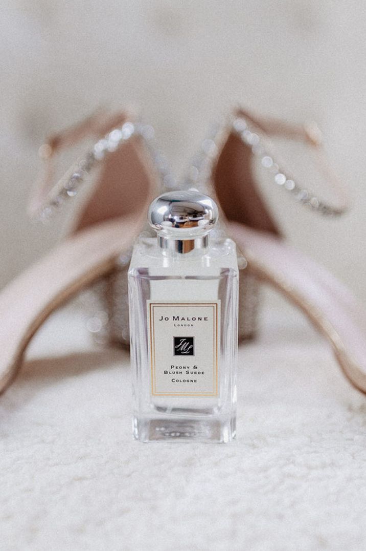 Peony & Blush Suede cologne Jo Malone wedding scent next to sparkly wedding shoes 